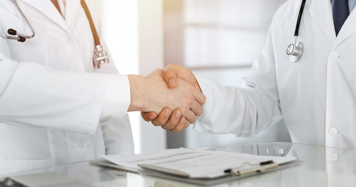 Two,Doctors,Are,Shaking,Hands,As,Agreement,About,Patient's,Treatment,